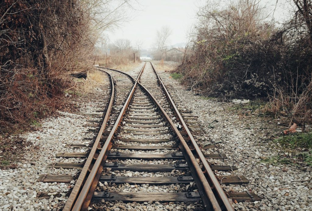 Railroad tracks, with one diverting to the left.