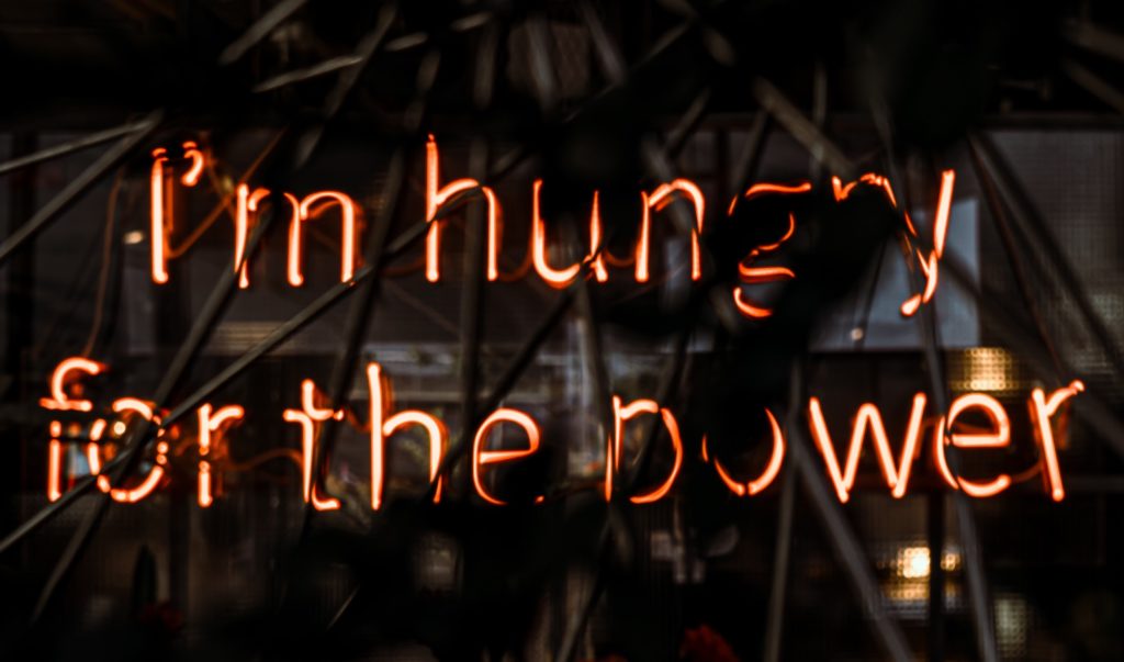 Neon sign stating, "I'm hungry for the power."