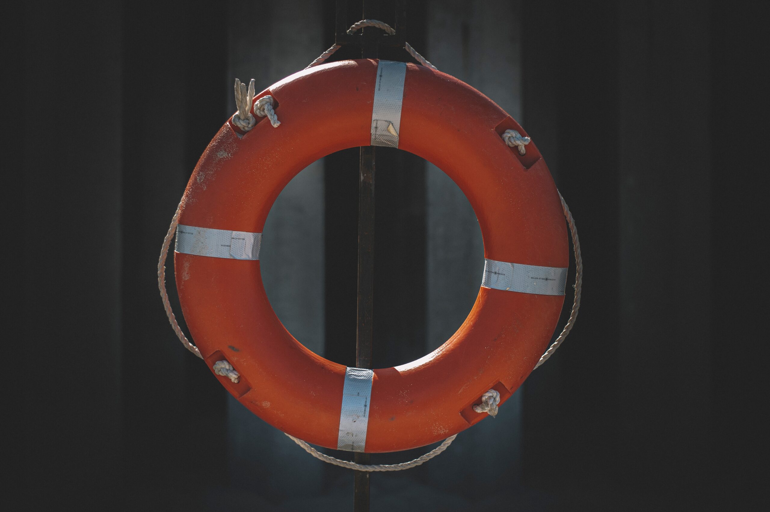 Circular life ring hanging on a pier.