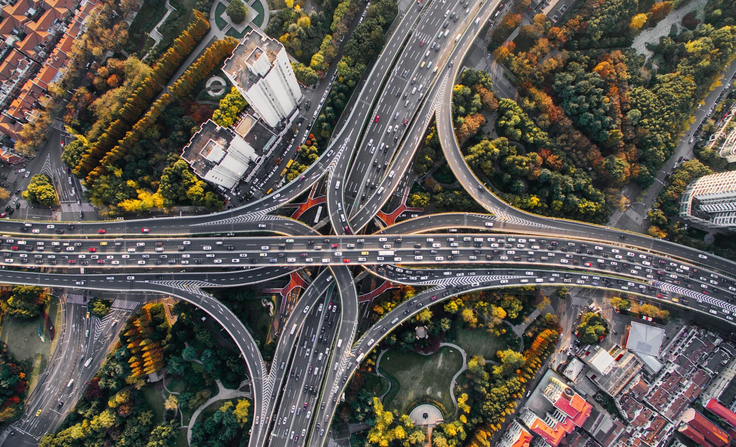 Birdseye view of a freeway interchange, with traffic flowing in all directions.