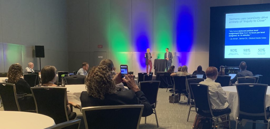Liz Arndt and Evan Liang at the front of a crowded ballroom breakout session at the 2022 Forrester B2B Summit North America. 