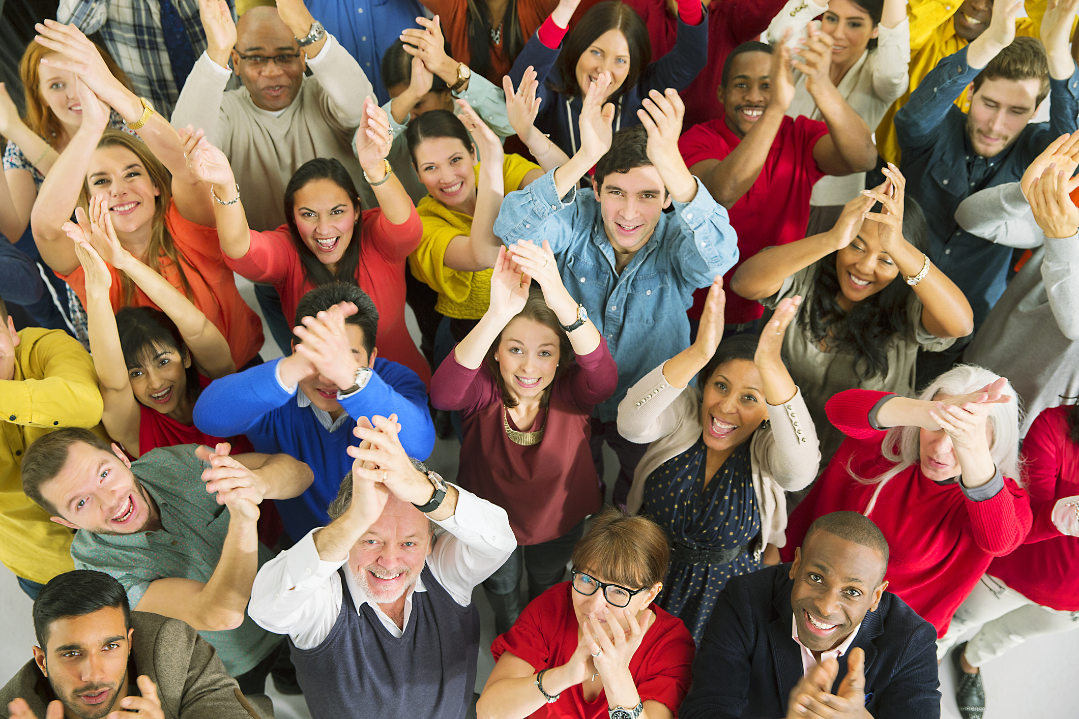 Portrait of diverse crowd clapping