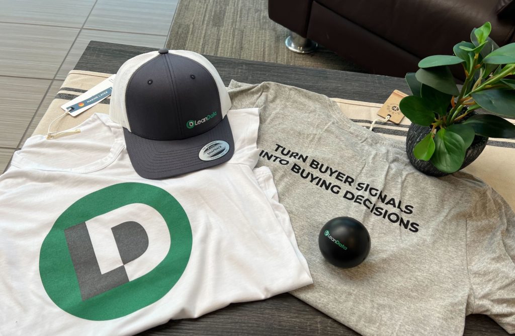Image of LeanData swag, including t-shirts, a trucker hat, and a stress ball.
