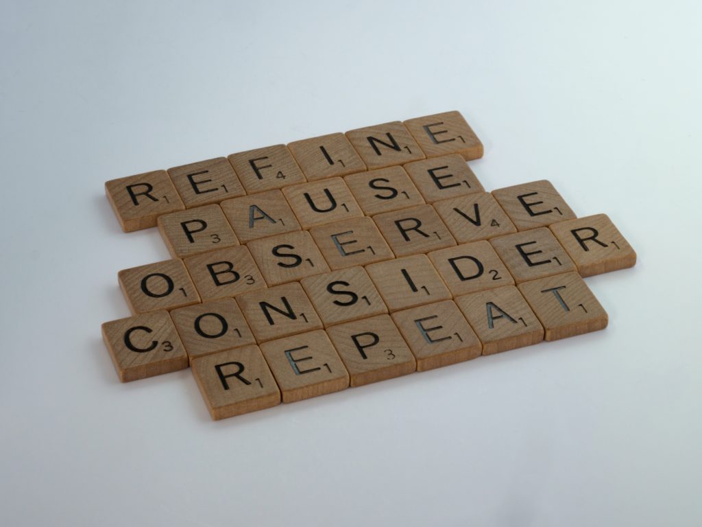 Scrabble tiles spelling the words Refine, Pause, Observe, Consider and Repeat.