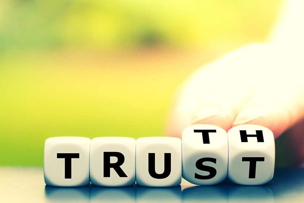 Blocks spelling "TRUST" with the last two, the 'S' and the 'T' spinning to reveal a 'T' and an 'H,' spelling "TRUTH."