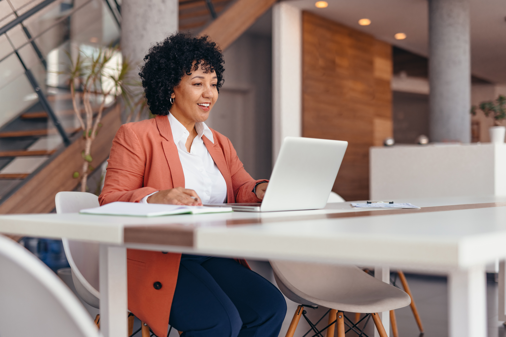 Portrait of Mature female entrepreneur brainstorming while using a laptop computer in the office.