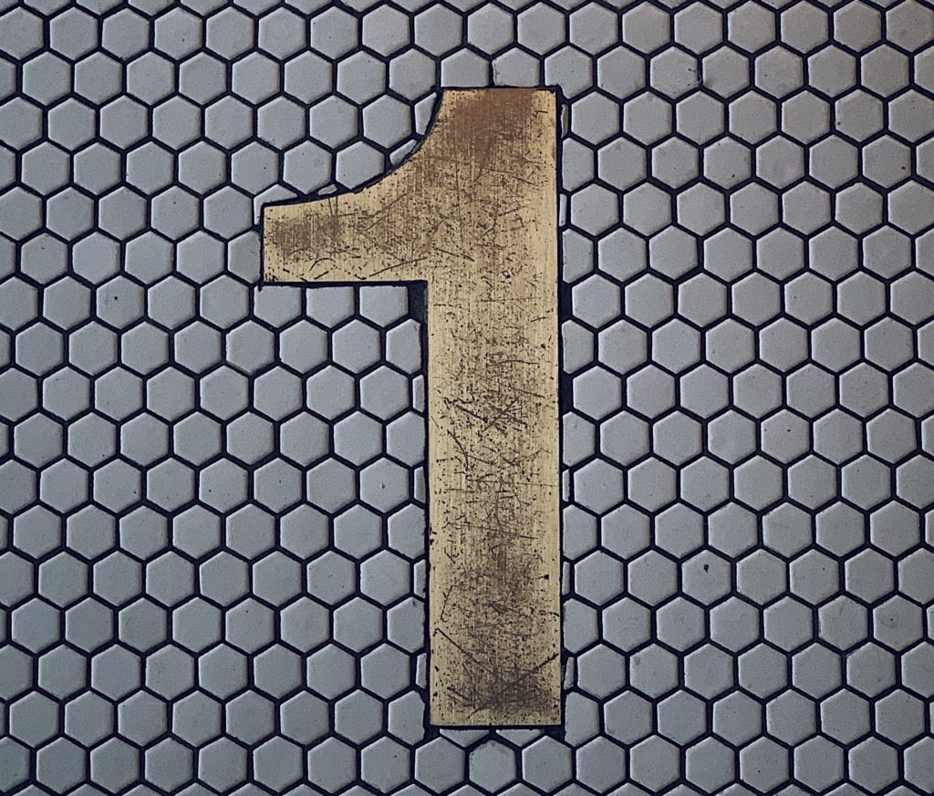 Numeral 1 on a tile wall.