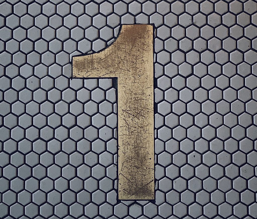 Numeral 1 on a tile wall.