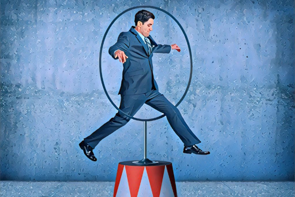 Image of a business person jumping through a hoop. 