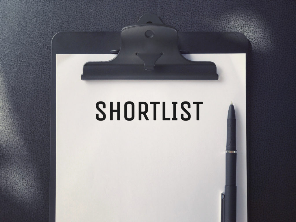 Image of a page on a clipboard, with the heading "Shortlist."