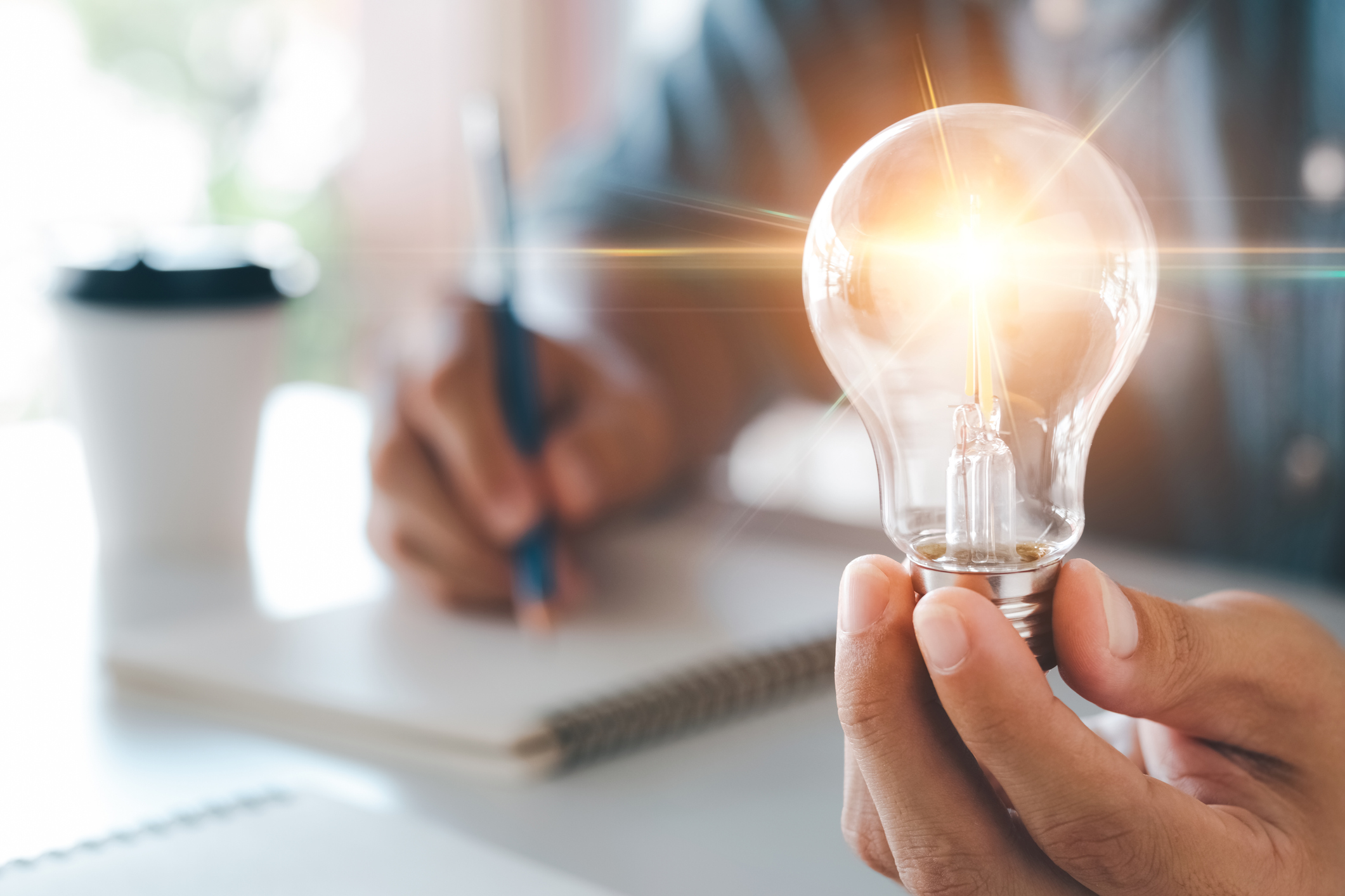 Hand holding light bulb to illuminate, idea of creativity and inspiration