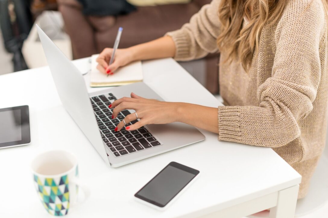 woman sitting at desk working on laptop