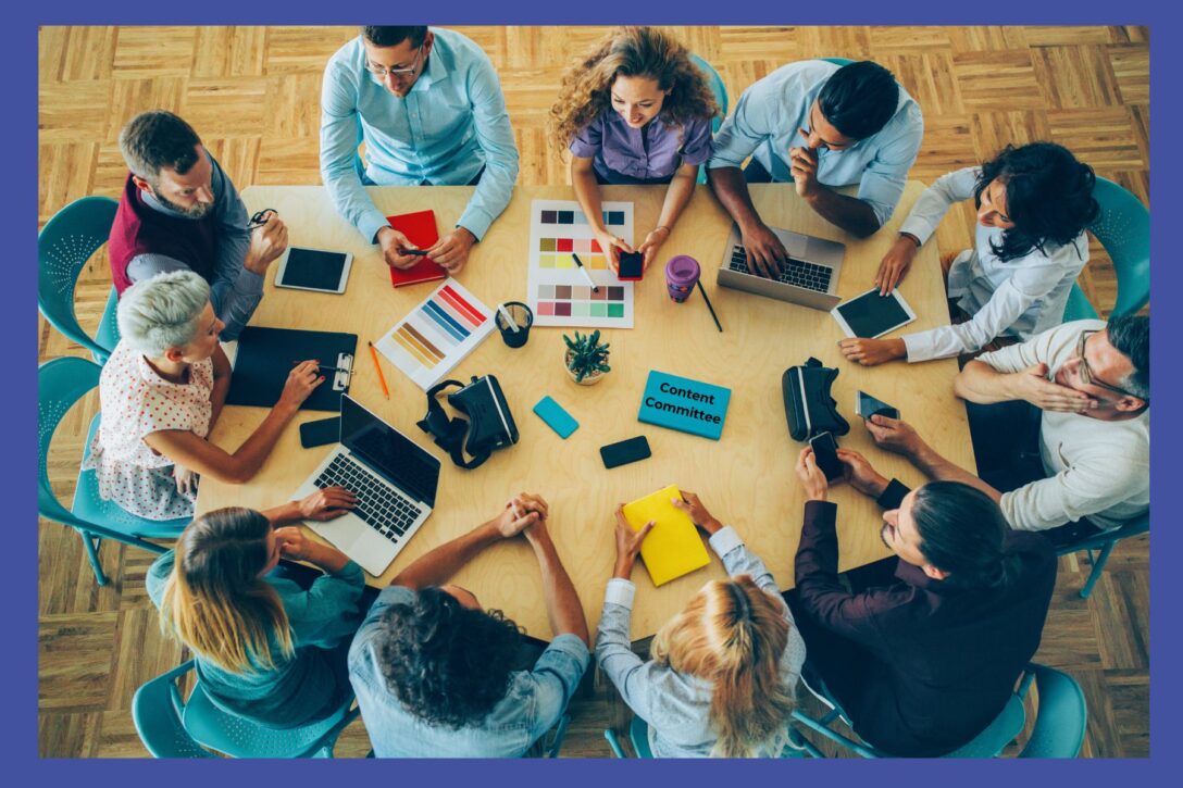 people sitting around a table at work having a meeting