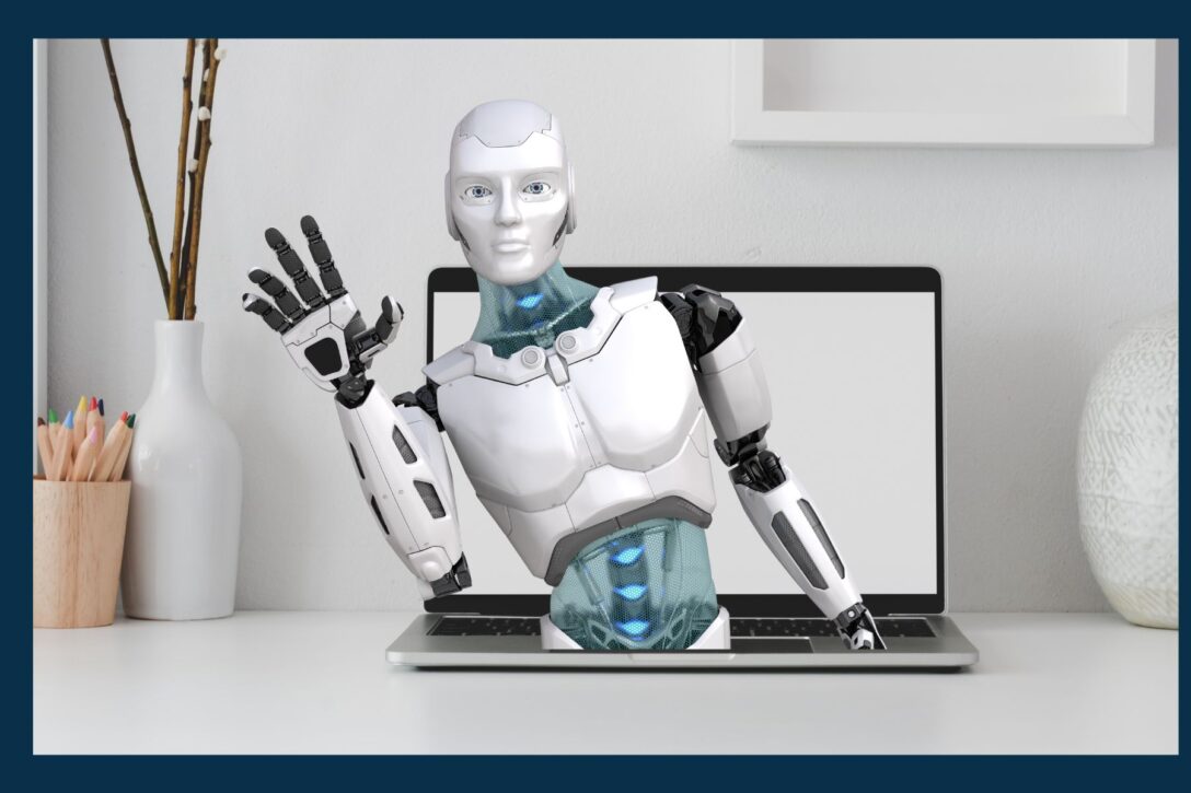 AI robot sticking out of the keyboard on a laptop computer