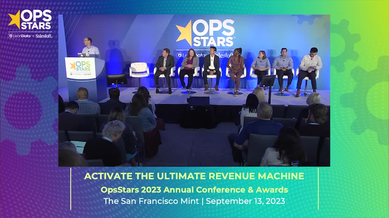 A blue and green gradient rectangle with an image of Salesloft employees from the OpsStars 2023 conference
