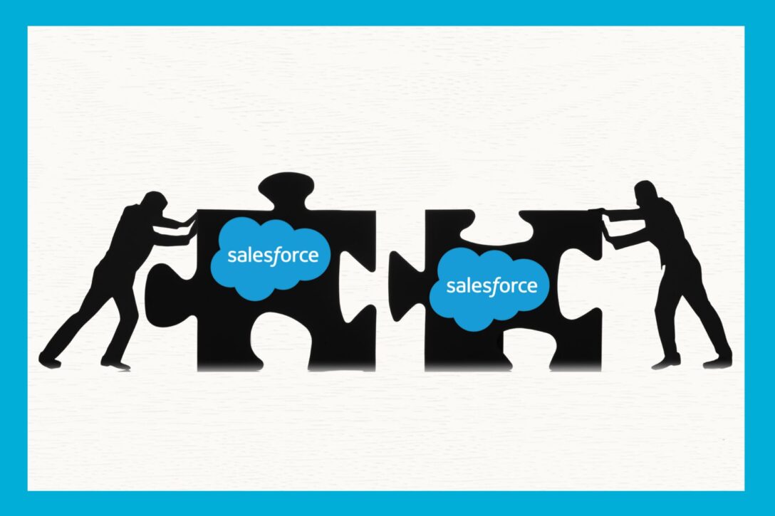 two people pushing two puzzle pieces together to represent merging Salesforce instances