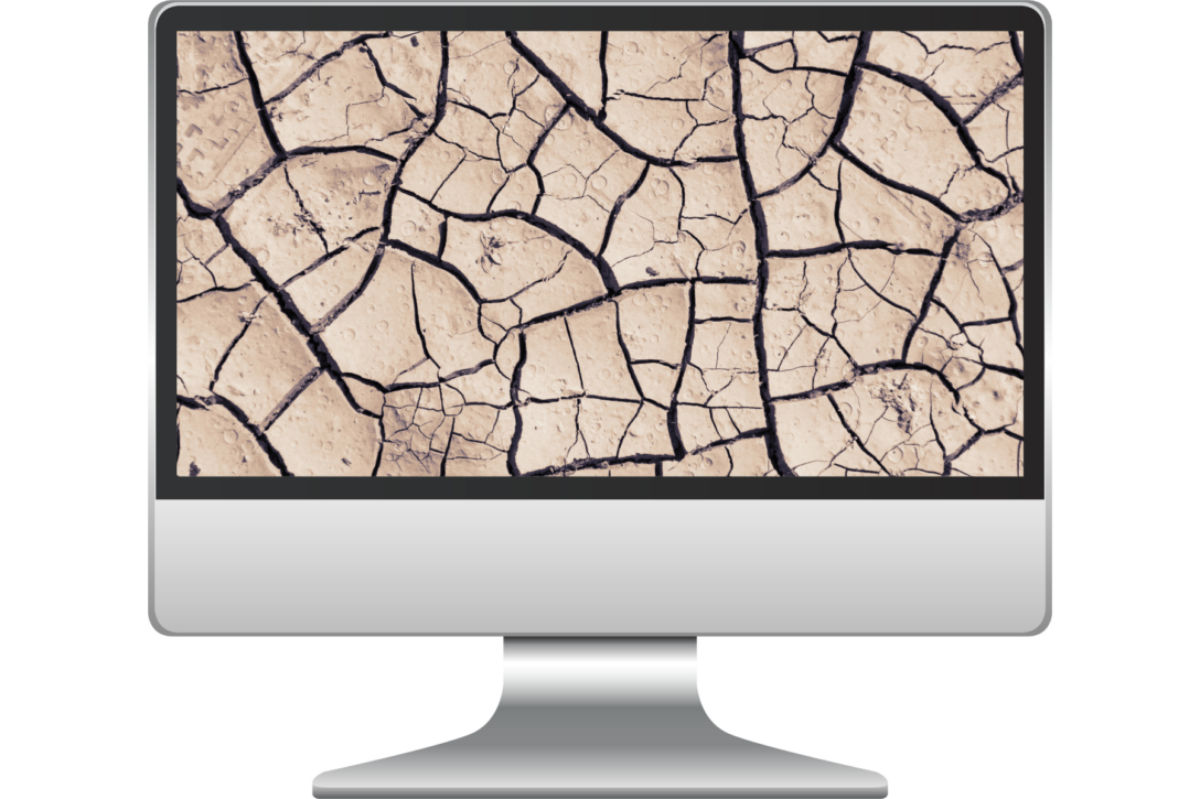 a silver computer monitor with an image of cracked dirt on the screen