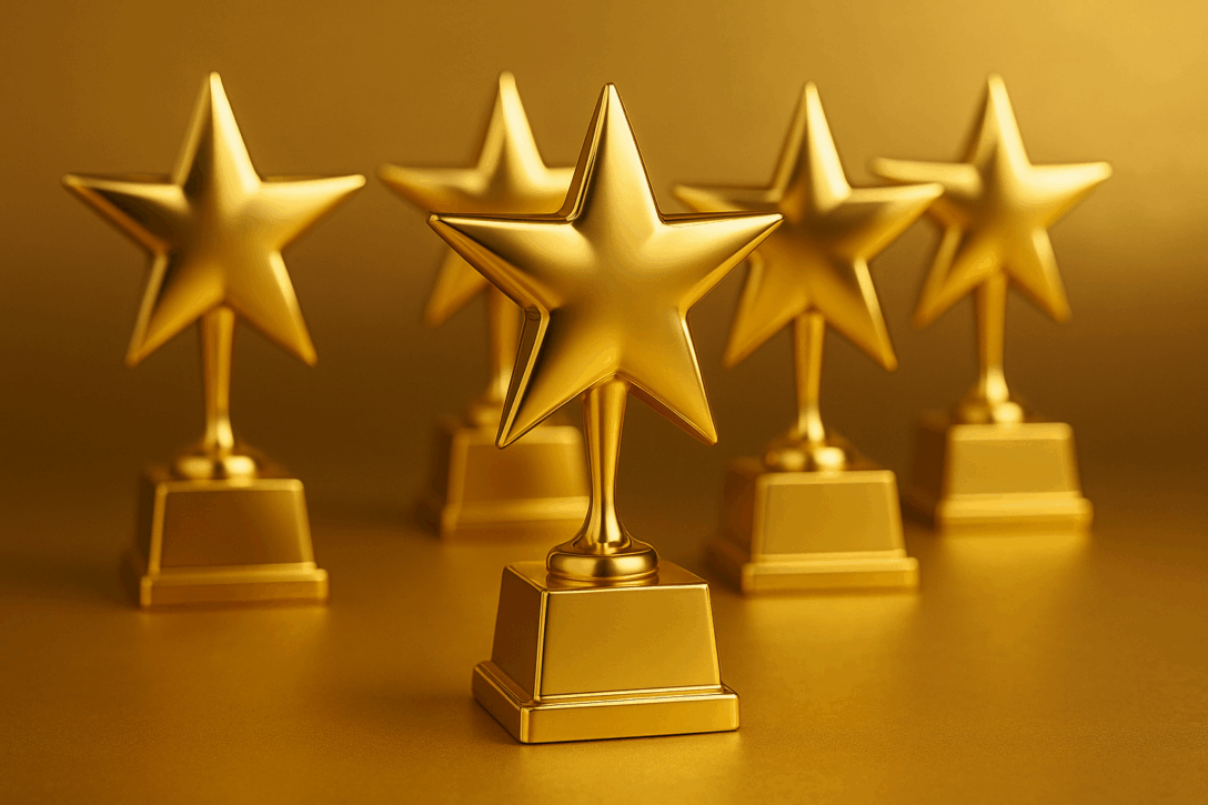 gold trophies with gold stars on top