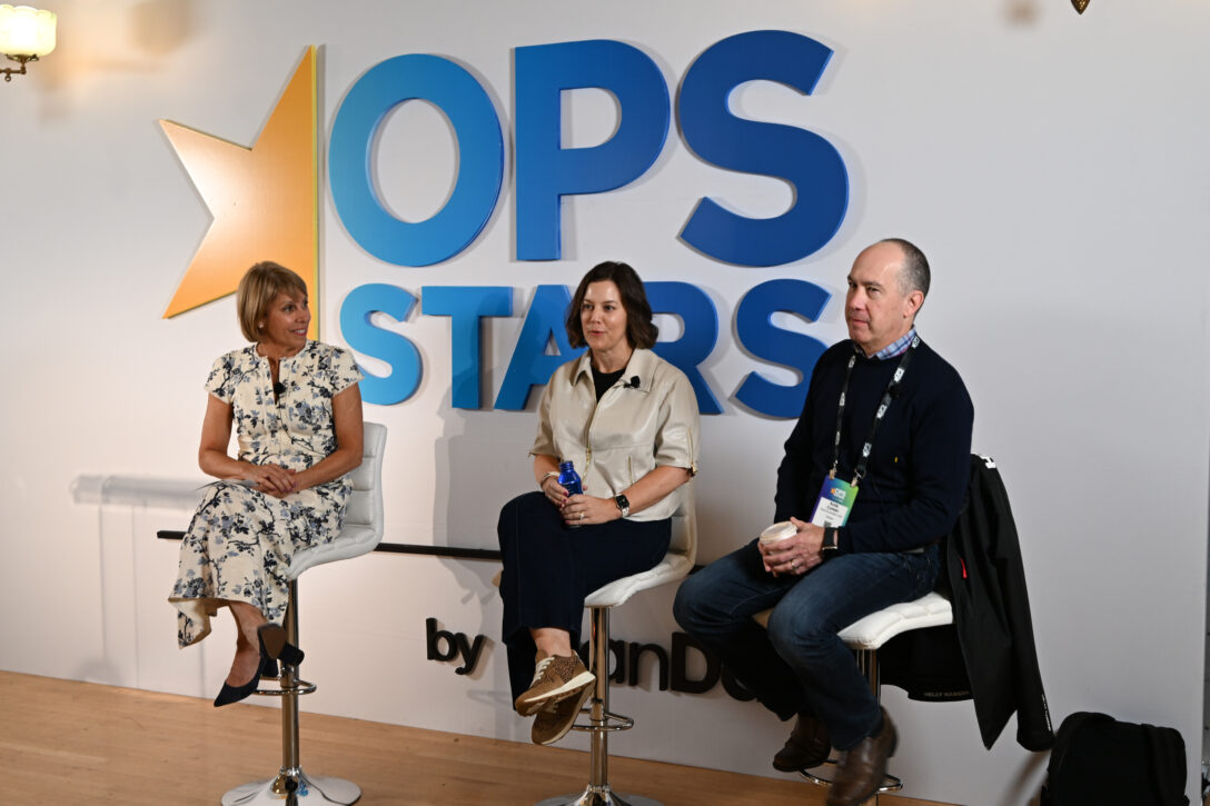 Katy Keim, Hilary Headlee, and Andy Cohen speaking at OpsStars 2025