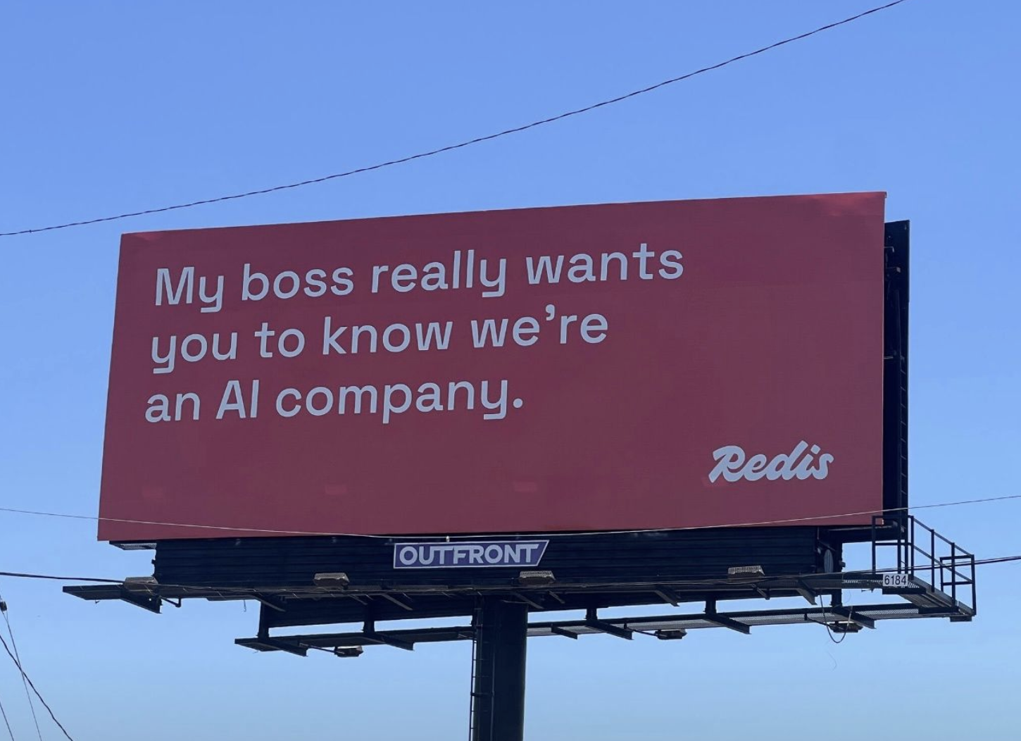 Billboard that says, "My boss really wants you to know we're an AI company."