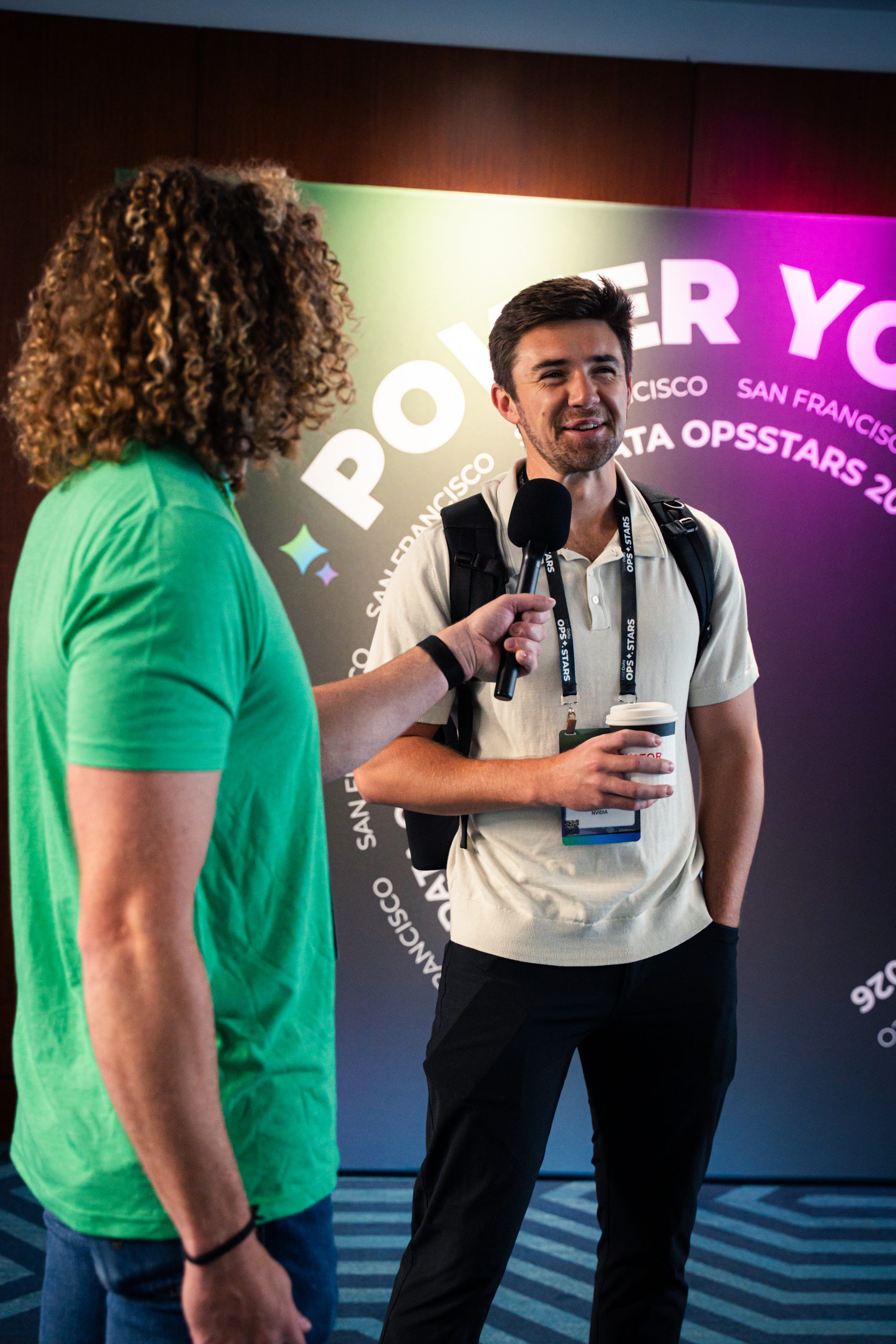 An OpsStars 2026 attendee is interviewed by the team.